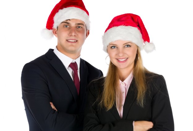 Man and Woman in business suits with Santa hats