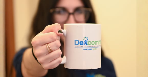 Dexcomm Answering and Communications Employee Holding a Mug