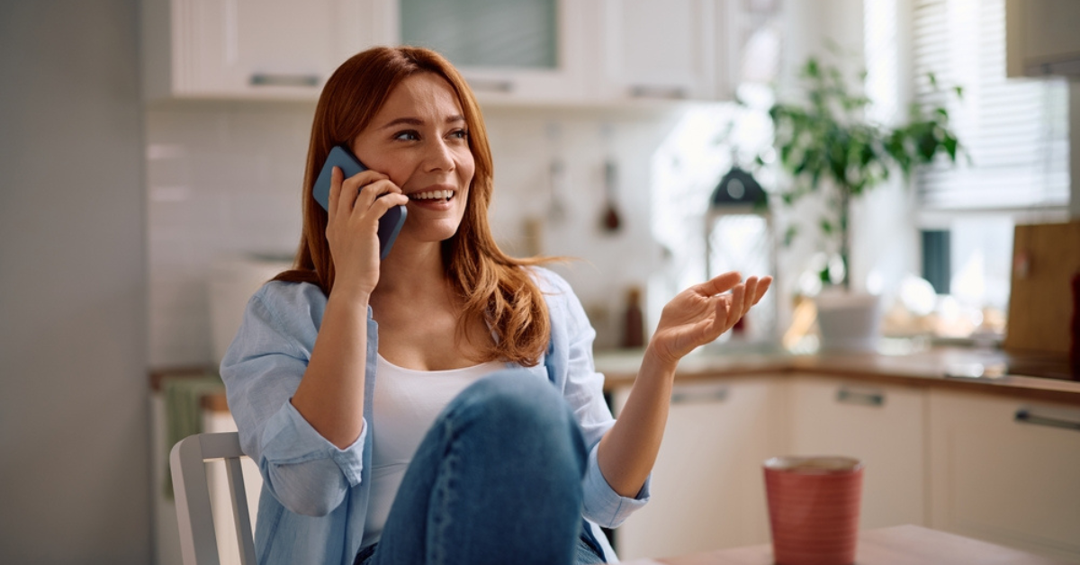 Lady taking a call at kitchen table