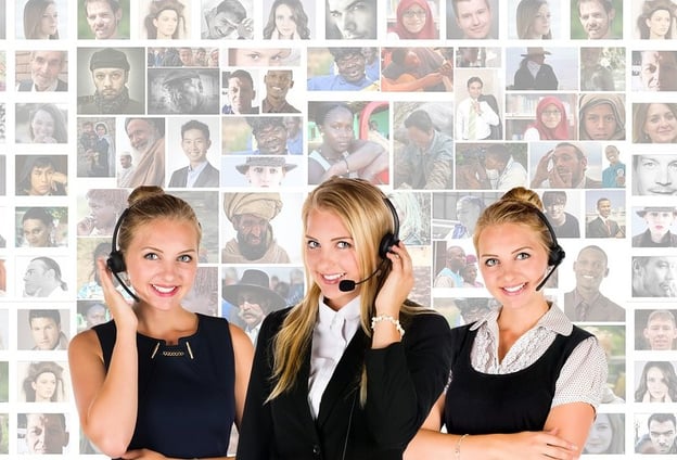Three women wearing headsets in front of a collage of people