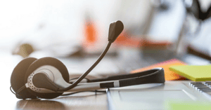 telecomm headset on computer keyboard