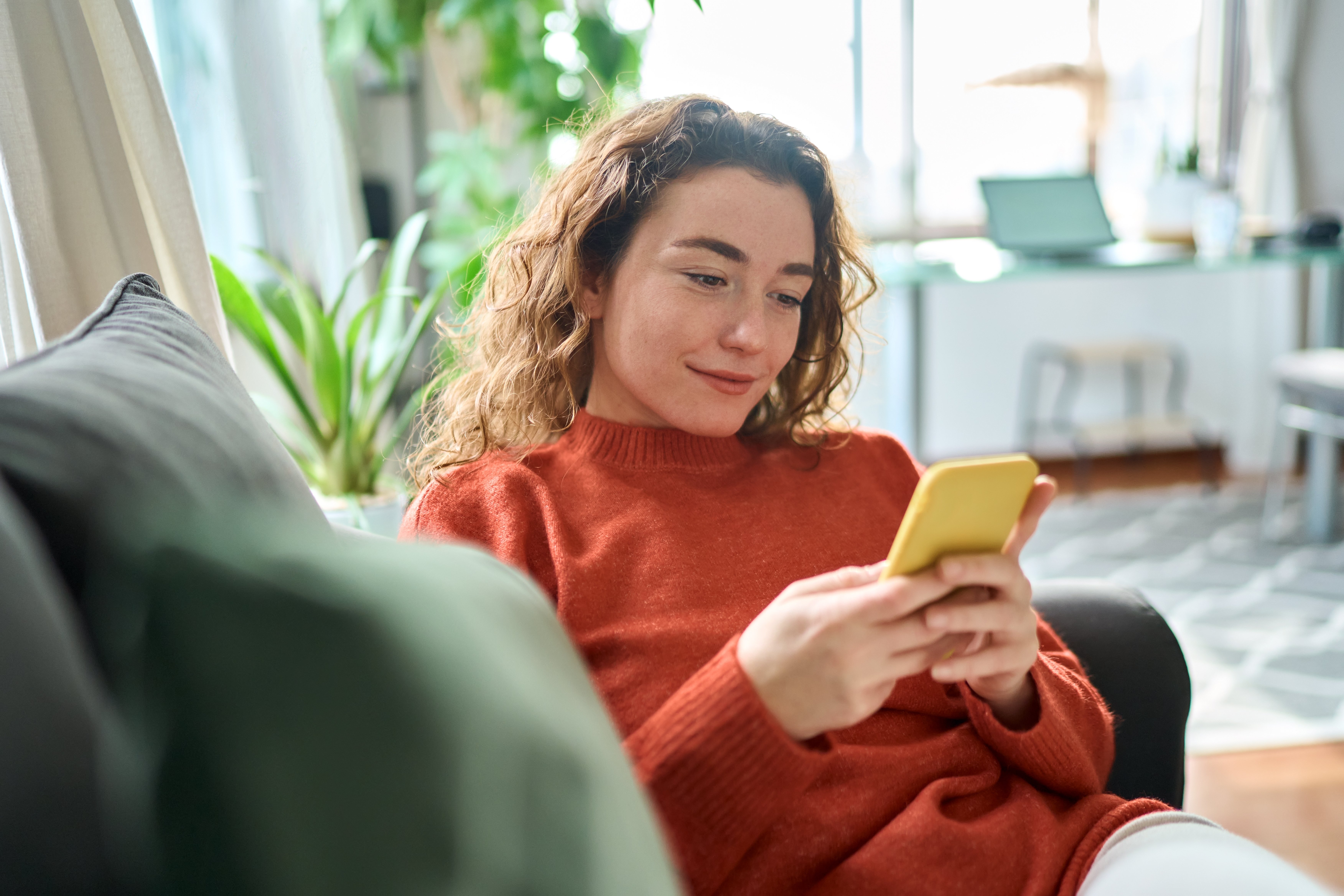Lady looking at smart phone and smiling