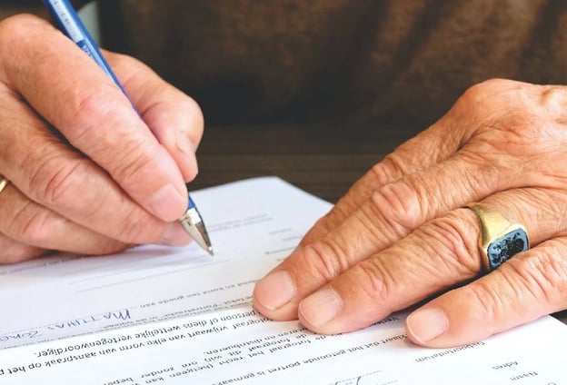 A man signing a confidentiality agreement